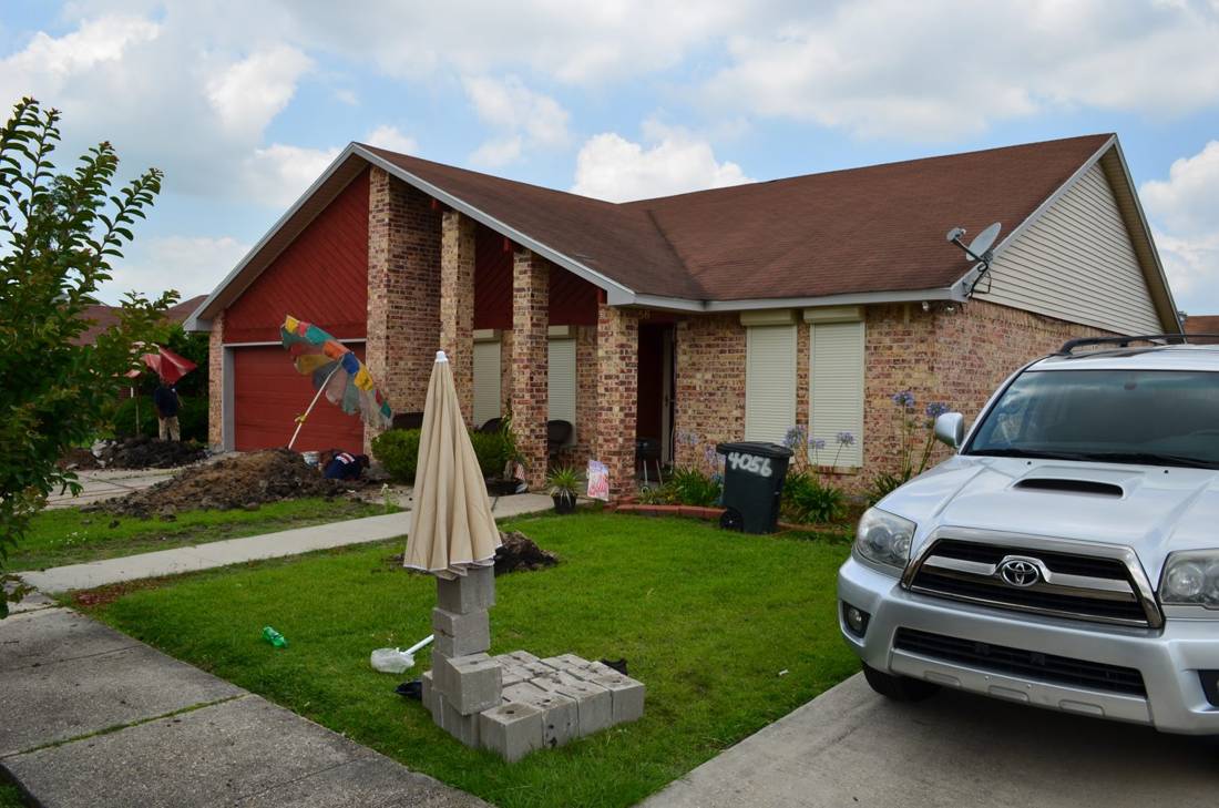 Brick home at grade before elevation